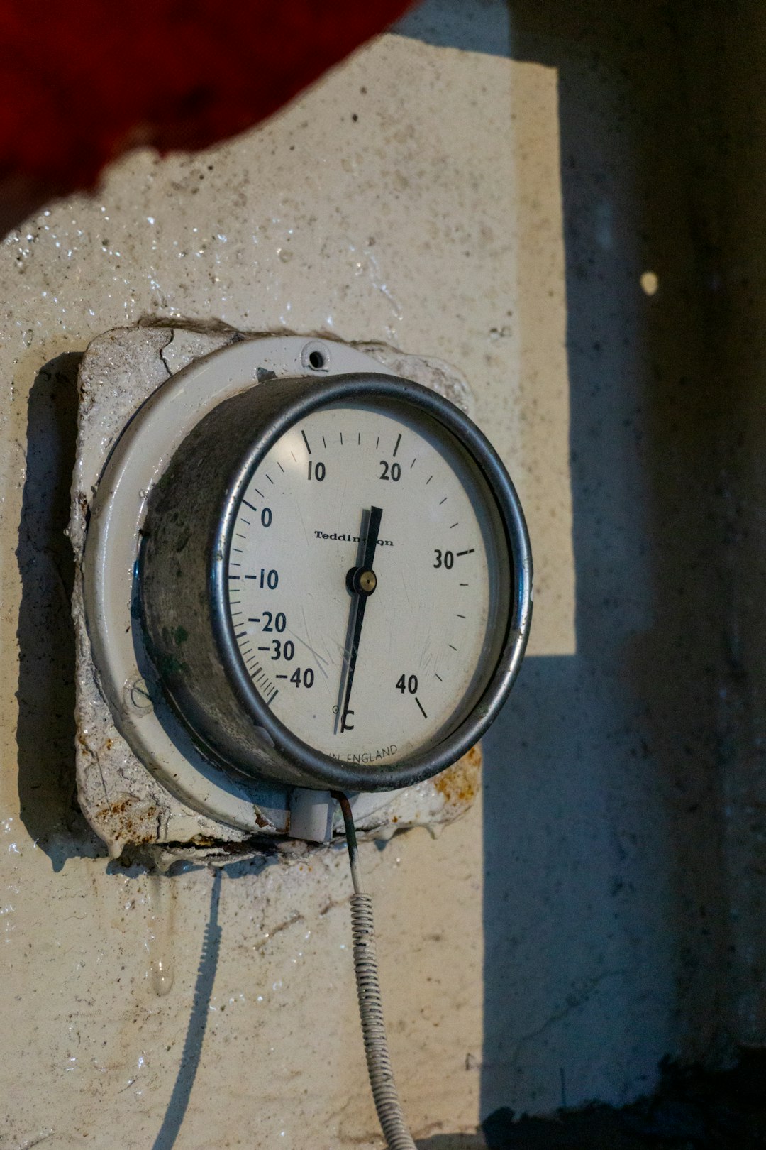 A close up of a thermometer on a wall